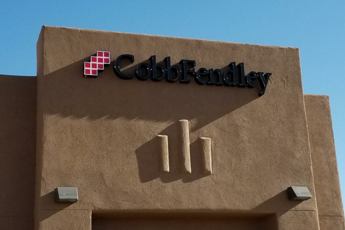 CobbFendley logo in black with red blocks on the outside of our office location in El Paso, Texas. The building is a brown stucco structure.