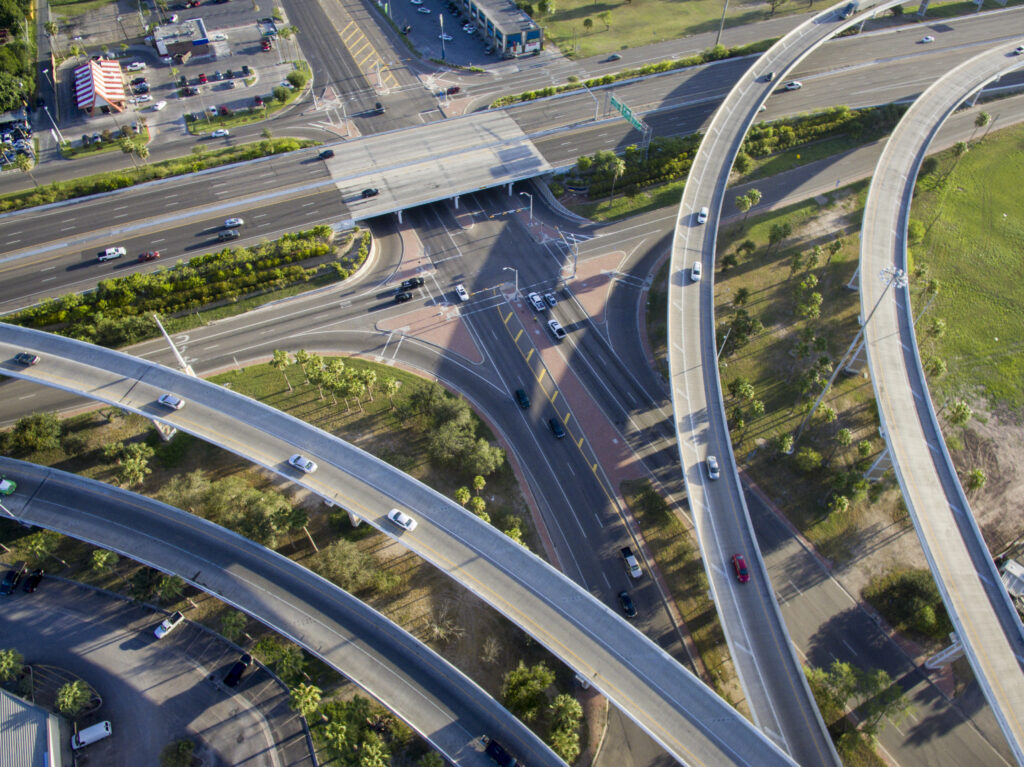 aerial view of roadways and elevated overpasses with cars driving