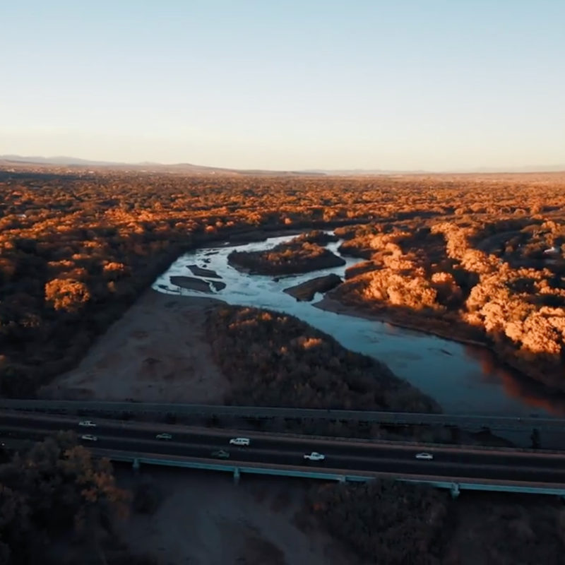 Arial view of highway crossing over river.