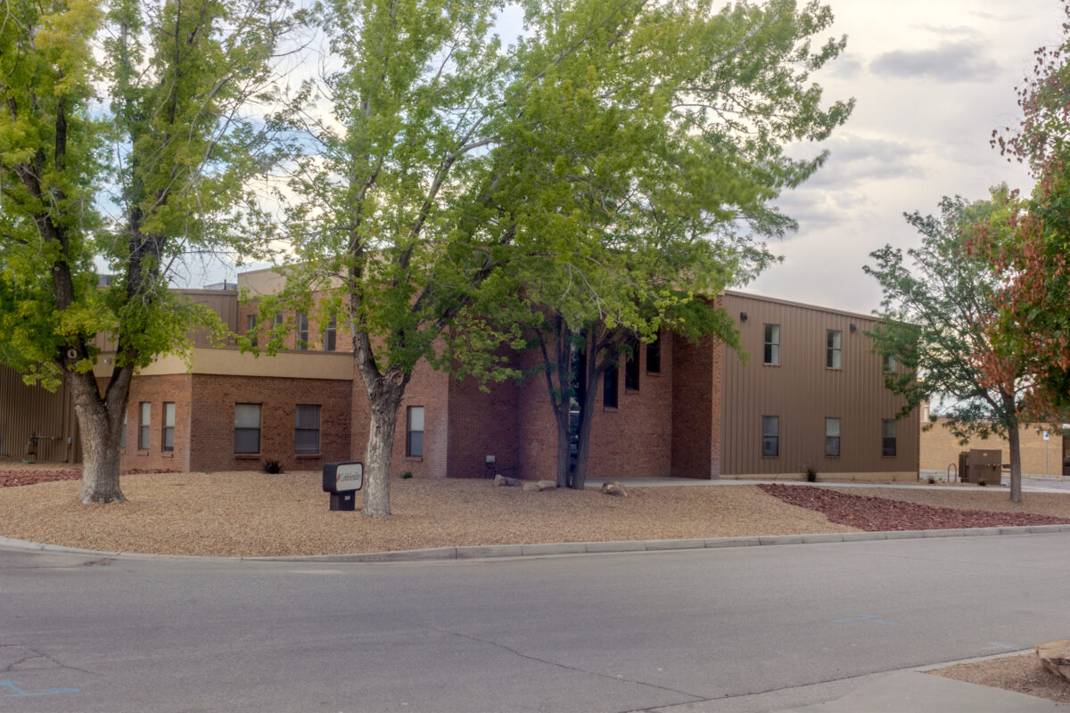 CobbFendley's Albuquerque office building. A two story brown building with trees in front of it and sign with the CobbFendley logo.