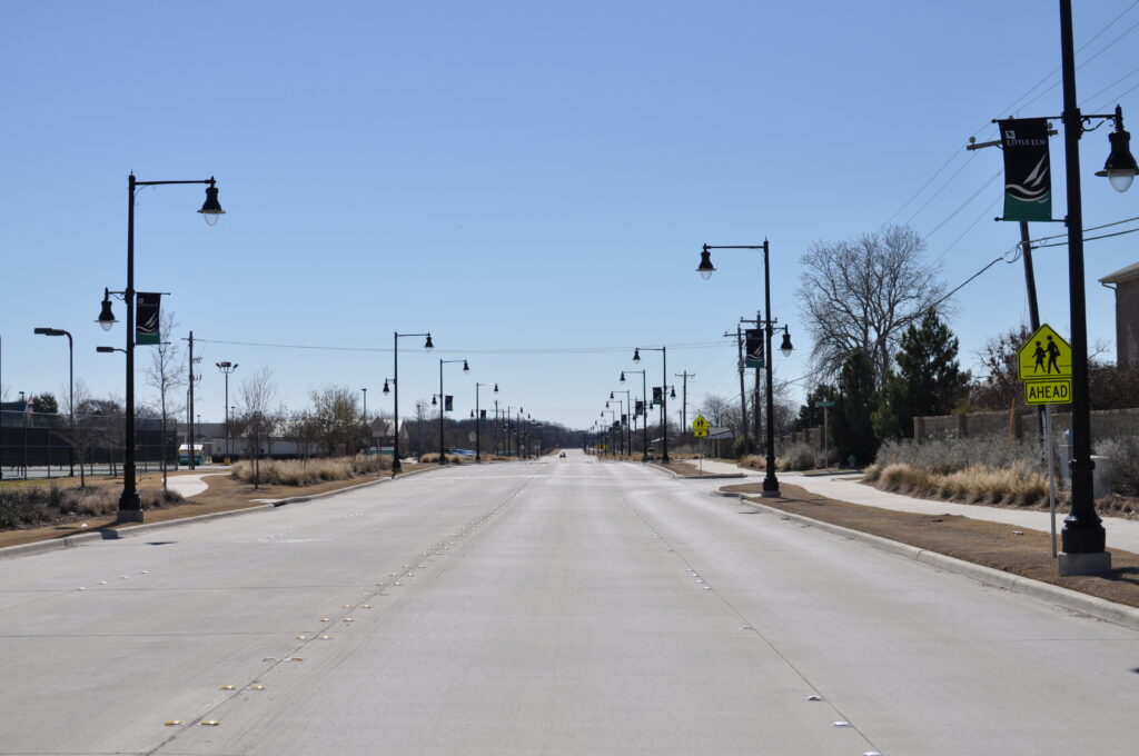 4 lane roadway with decorative light poles and pedestrian crossings in Frisco, Texas